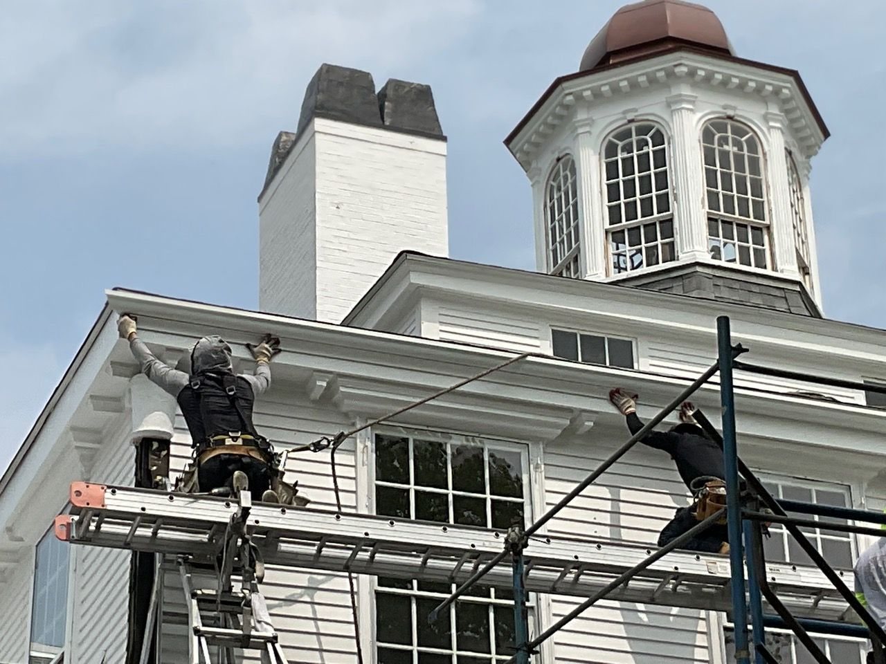 Art Slate Roofing crew restoring a historic white Boston building with cupola
